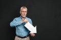 Image of frustrated bearded gentleman 60s with grey hair wearing