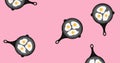 Image of frying pans with fried eggs falling on pink background