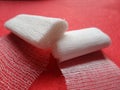 Gauze rolls for medical help with red background