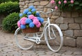 Quaint Old-Fashioned White Bicycle with Hydrangea Flowers in Front of Stone Wall Royalty Free Stock Photo
