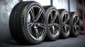 Car wheels. Four new black tyres with alloy discs in garage. gen Royalty Free Stock Photo