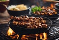 Indonesian lamb satay skewers served on iron hot plate