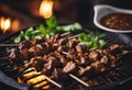 Indonesian lamb satay skewers served on iron hot plate