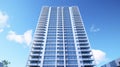 A modern high - rise condominium building against a blue sky backdrop Royalty Free Stock Photo