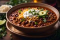 A steaming bowl of homemade vegan chili topped with diced onions and a dollop of dairy-free sour cream