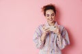 Image of ginger smiling woman playing video game on cellphone Royalty Free Stock Photo