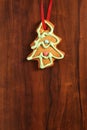 Image of gingerbread Christmas tree cookie over brown wooden tex Royalty Free Stock Photo