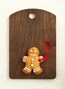 Image of Gingerbread man on brown cutting board