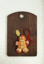 Image of Gingerbread man on brown cutting board