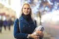 Image of girl in coat with gift in box Royalty Free Stock Photo