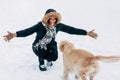 Image of girl hugging labrador in winter park for walk