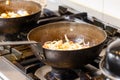 Commercial Kitchen Scene with Woks on Stoves Royalty Free Stock Photo