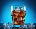 close up of a glass of cola with ice cubes.