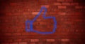 Image of glowing neon thumb up icon on brick wall