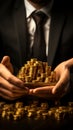 Image Gold bullion in businessmans hands, symbolizing success against stock charts