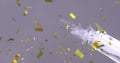 Image of gold confetti with champagne being open on grey background