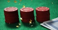 Image of gold stars falling over two three stack of casino chips and card on green background Royalty Free Stock Photo