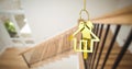 Image of golden key with house shape over stairs in house Royalty Free Stock Photo