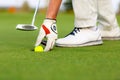 Male hand is putting out a ball from golf hole Royalty Free Stock Photo