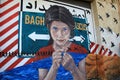 Emotional image of barbed wire, black birds and young girl, painted on the side of old wall in the city, Rochester, New York, 2017