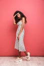 Image of gorgeous african american woman with curly hair looking at camera