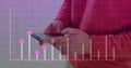 Image of graph on grid pattern over midsection of man standing and using cellphone Royalty Free Stock Photo