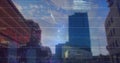 Image of graphs, binary codes, computer language, low angle view of buildings against sky Royalty Free Stock Photo