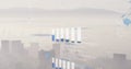 Image of graphs, globes, soundwaves over fog covered cityscape against mountain and sky