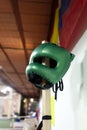 An image of a green boxing helmet in a boxing gym