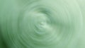 An image of a green carpet blurs swirling circles