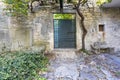 Image of a green entrance door to a residential building with an antique faÃÂ§ade