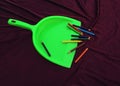 Green garbage cleaner with pencil isolated on black background Royalty Free Stock Photo