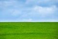 Image of green grass field and bright blue sky Royalty Free Stock Photo