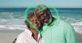 Image of green hearts over african american senior couple on the beach