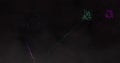 Image of green and pink fireworks exploding on black background
