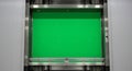 A Green Screen Inside a Modern Elevator Shaft: Chroma Key Background for Visual Effects and Media Production Royalty Free Stock Photo
