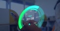 Image of green speedometer over hands of caucasian man using smartphone