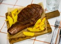 Image of a grilled beef steak and fried potatoes. Royalty Free Stock Photo