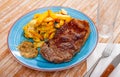 Image of a grilled beef steak and fried potatoes. Royalty Free Stock Photo