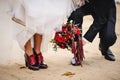 The image of the groom holding a wedding bouquet of flowers in hand..Black suit. A beautiful bouquet..A bouquet of red, claret Royalty Free Stock Photo