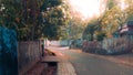 The image shows a road with trees on the side, under a clear sky. Royalty Free Stock Photo