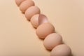 Image of a group of whole chicken eggs and half an egg shell among it.