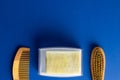 Image of hair brush, comb and soap with copy space on blue background