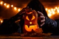 Image of halloween pumpkin cut in shape of face with witch Royalty Free Stock Photo