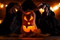 Image of halloween pumpkin cut in shape of face with witch Royalty Free Stock Photo