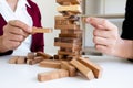 Image of hand holding blocks wood game to growing up of business. Risk of management and strategy plan