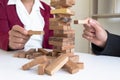 Image of hand holding blocks wood game to growing up of business. Risk of management and strategy plan