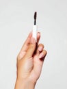 An image of a hand holding mascara make up on white background Royalty Free Stock Photo