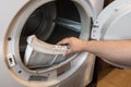 hand removing lint filter from clothes dryer Royalty Free Stock Photo