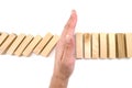 Risk and Strategy in Business, Image of hand stopping falling collapse wooden block dominoes effect from continuous toppled block, Royalty Free Stock Photo